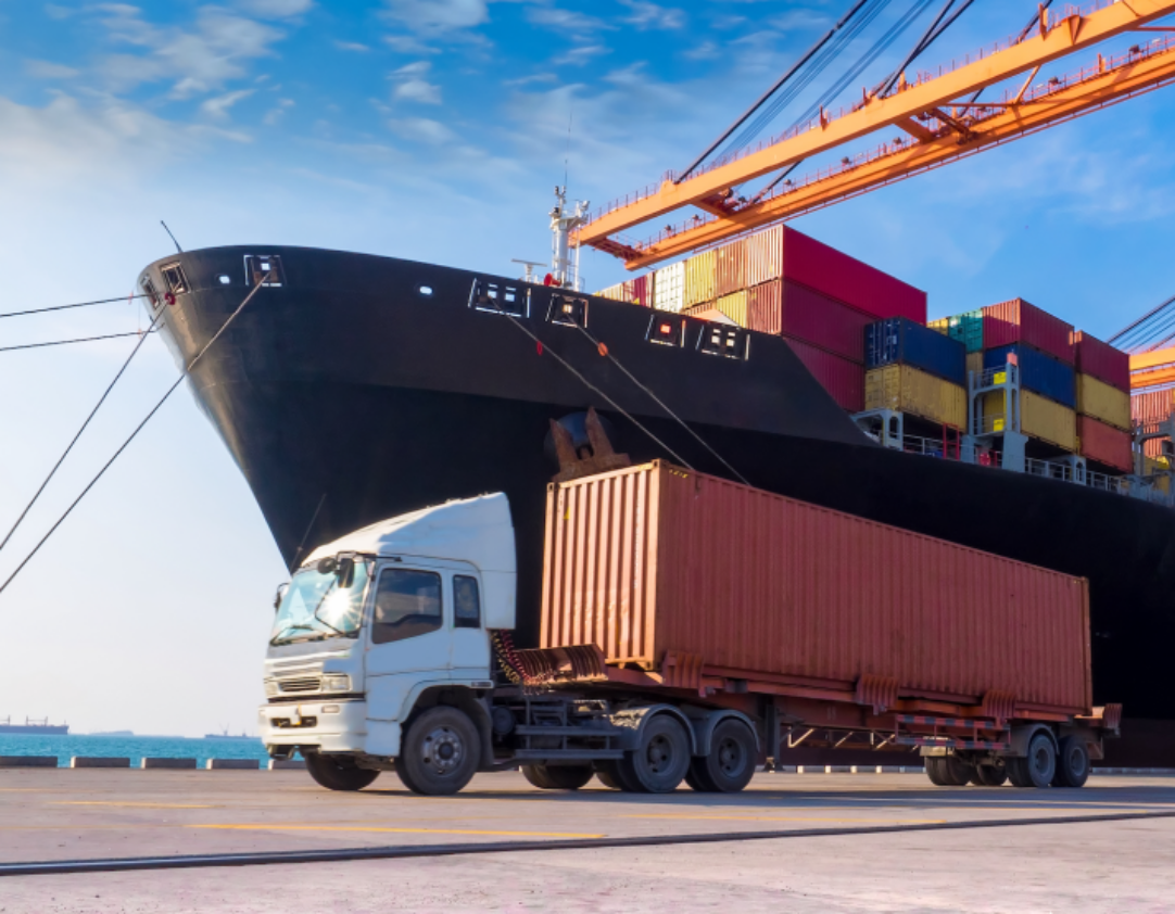 truck in-front of shipping boat