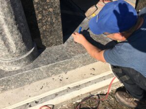 Installer ensuring mausoleum is set correctly.